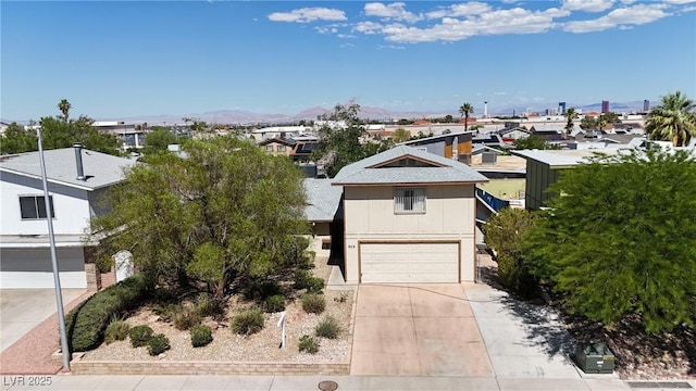 909 Biljac St, Las Vegas, NV 89145 - view of front facade featuring an attached garage, driveway, a residential view, and a mountain view