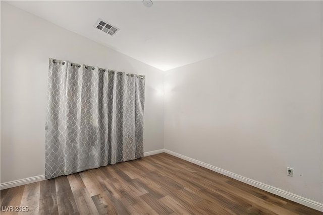 8843 Tomnitz Ave Unit 102, Las Vegas, NV 89178 - spare room featuring wood finished floors and vaulted ceiling