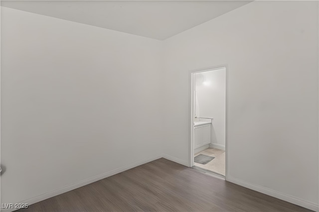 8843 Tomnitz Ave Unit 102, Las Vegas, NV 89178 - unfurnished room featuring wood finished floors and baseboards