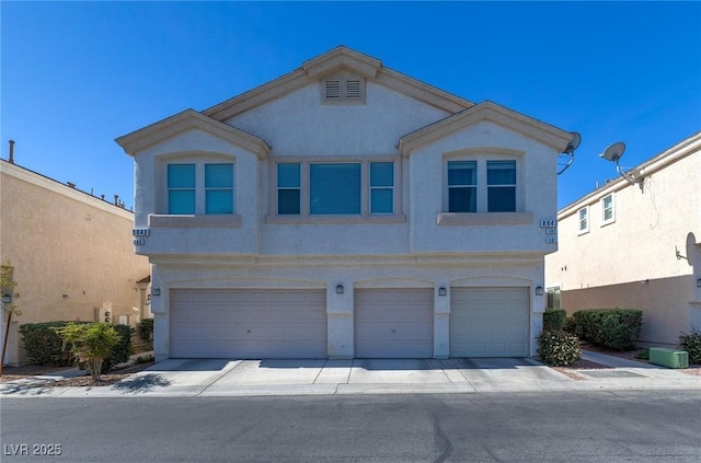 8843 Tomnitz Ave Unit 102, Las Vegas, NV 89178 - view of front of house featuring an attached garage, stucco siding, and concrete driveway