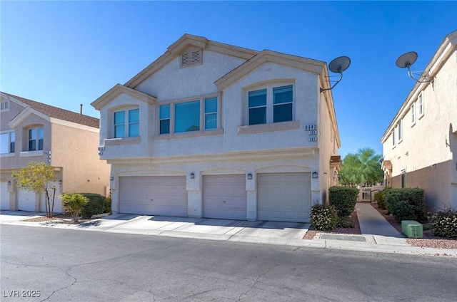 8843 Tomnitz Ave Unit 102, Las Vegas, NV 89178 - view of property with stucco siding and a garage