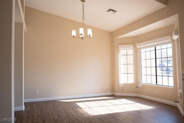 904 Swift Bear St, Henderson, NV 89002 - spare room featuring wood finished floors, lofted ceiling, and a chandelier