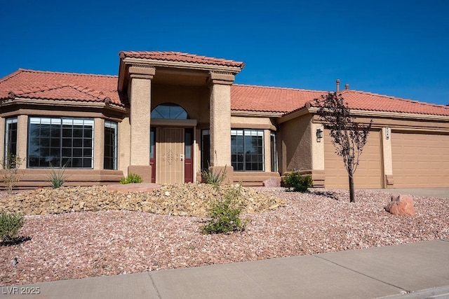 904 Swift Bear St, Henderson, NV 89002 - view of front of house with stucco siding, an attached garage, a tiled roof, and concrete driveway