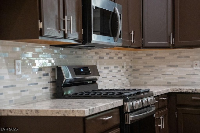 904 Swift Bear St, Henderson, NV 89002 - kitchen with appliances with stainless steel finishes, dark brown cabinetry, light countertops, and backsplash