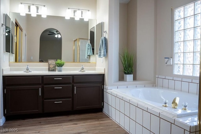 904 Swift Bear St, Henderson, NV 89002 - bathroom featuring ceiling fan, double vanity, a bath, and wood finished floors