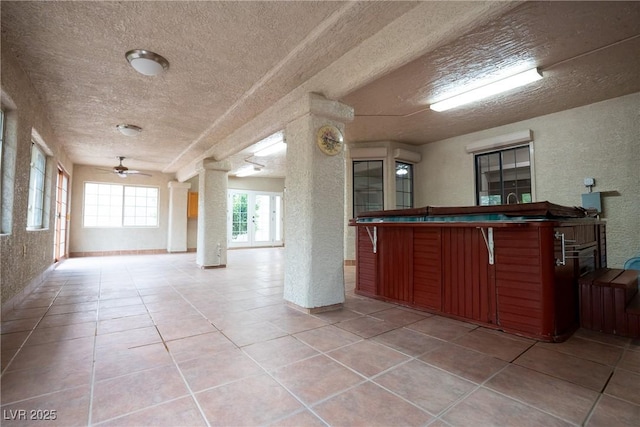 904 Swift Bear St, Henderson, NV 89002 - kitchen featuring a textured ceiling, open floor plan, a ceiling fan, a textured wall, and light tile patterned floors