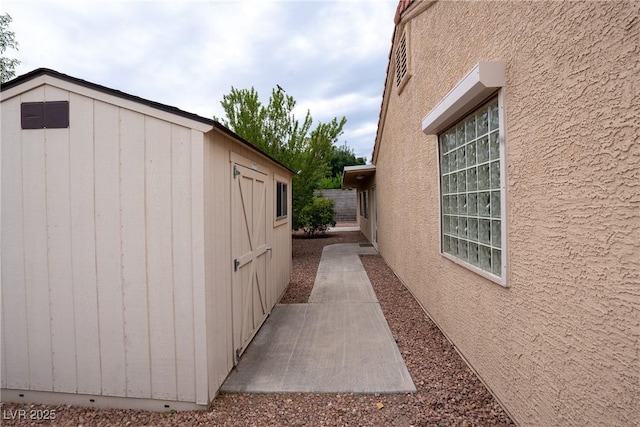 904 Swift Bear St, Henderson, NV 89002 - view of property exterior featuring stucco siding, a patio, and an outdoor structure