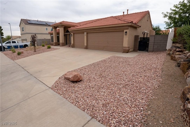 904 Swift Bear St, Henderson, NV 89002 - mediterranean / spanish-style house with a tiled roof, a garage, driveway, stucco siding, and a gate