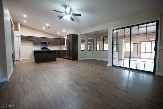 904 Swift Bear St, Henderson, NV 89002 - kitchen featuring open floor plan, a ceiling fan, stainless steel microwave, lofted ceiling, and dark wood-type flooring