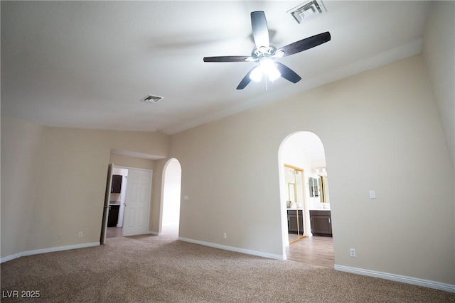 904 Swift Bear St, Henderson, NV 89002 - spare room featuring arched walkways, vaulted ceiling, light colored carpet, and a ceiling fan