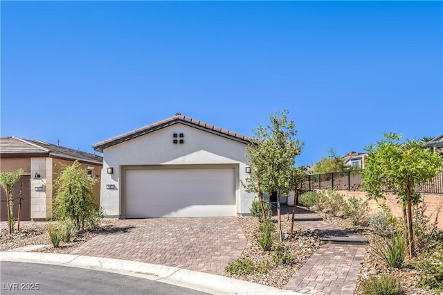 187 Palm Fox Ct, Henderson, NV 89011 - view of front of property with stucco siding, decorative driveway, a tiled roof, and a garage