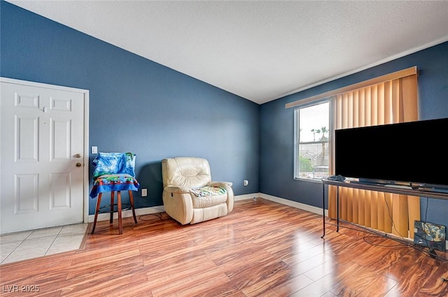 5055 W Hacienda Ave Unit 2003, Las Vegas, NV 89118 - sitting room with lofted ceiling and wood finished floors