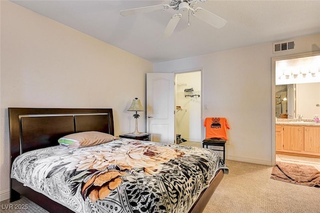 5055 W Hacienda Ave Unit 2003, Las Vegas, NV 89118 - bedroom with light carpet, ceiling fan, a walk in closet, and ensuite bath