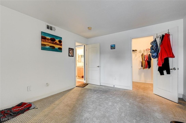 5055 W Hacienda Ave Unit 2003, Las Vegas, NV 89118 - unfurnished bedroom featuring carpet flooring and a walk in closet