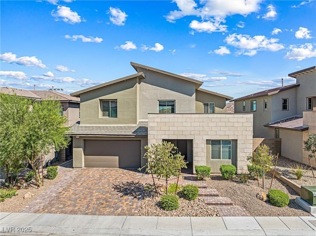 12415 Notch Trail Ave, Las Vegas, NV 89138 - view of front of home with decorative driveway, an attached garage, and stucco siding