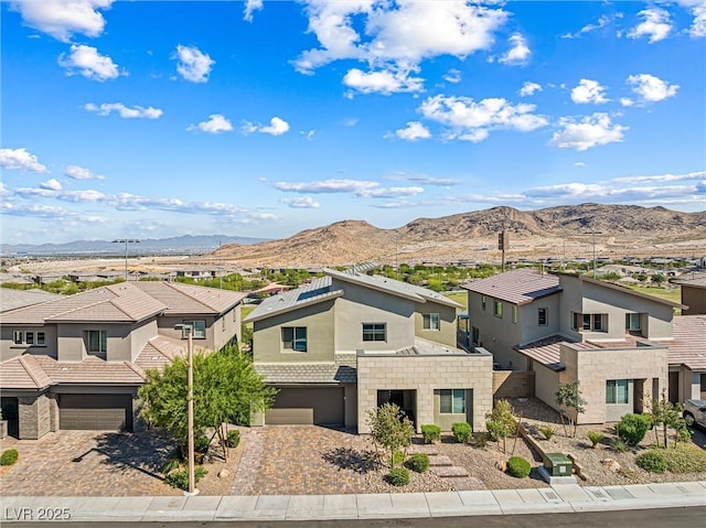 12415 Notch Trail Ave, Las Vegas, NV 89138 - view of front of home with a residential view, a garage, a mountain view, decorative driveway, and stucco siding
