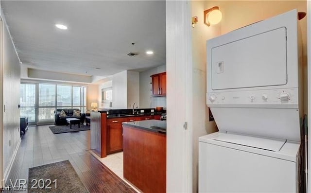 4525 Dean Martin Dr Unit 2203, Las Vegas, NV 89103 - laundry area featuring estacked washer and dryer, light wood-style floors, and recessed lighting