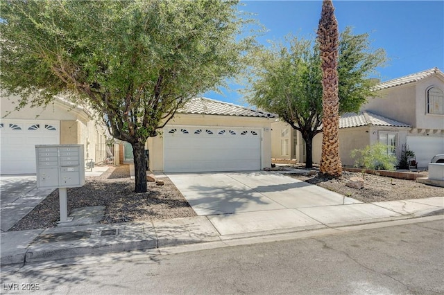 6009 Flowering Plum Ave, Las Vegas, NV 89142 - view of front facade with stucco siding, concrete driveway, a garage, and a tiled roof