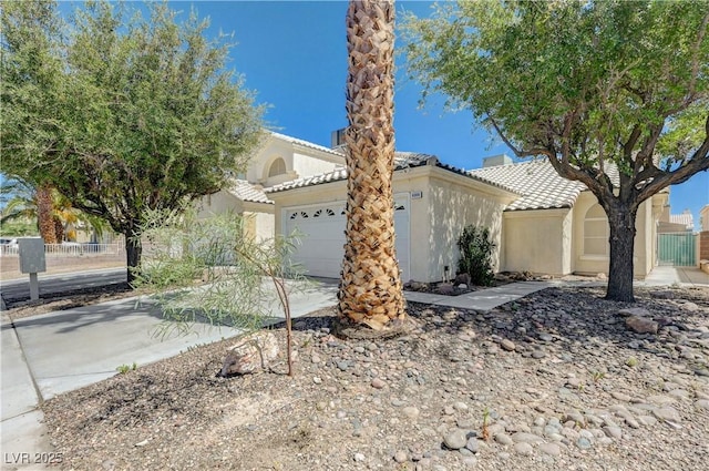 6009 Flowering Plum Ave, Las Vegas, NV 89142 - view of front facade featuring a garage, a tile roof, stucco siding, and driveway