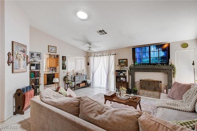 6009 Flowering Plum Ave, Las Vegas, NV 89142 - living area with light tile patterned flooring, a tile fireplace, lofted ceiling, and ceiling fan