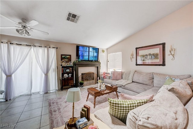 6009 Flowering Plum Ave, Las Vegas, NV 89142 - living area featuring a fireplace, vaulted ceiling, a ceiling fan, and tile patterned flooring