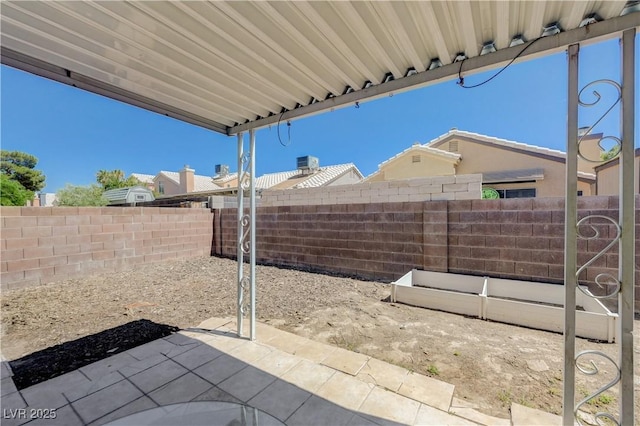 6009 Flowering Plum Ave, Las Vegas, NV 89142 - fenced backyard with a patio area