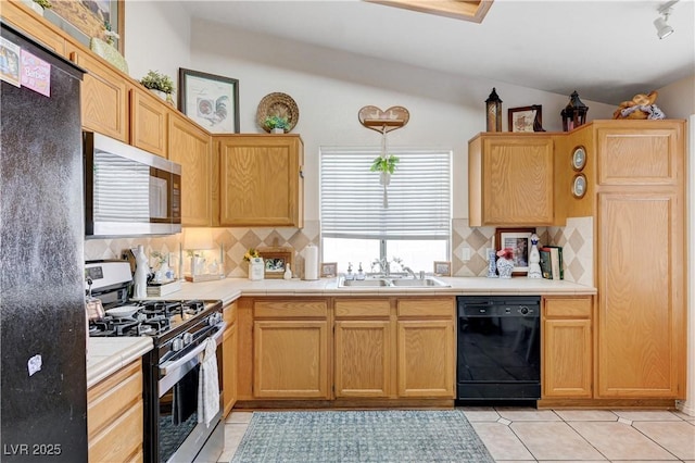 6009 Flowering Plum Ave, Las Vegas, NV 89142 - kitchen with stainless steel appliances, lofted ceiling, decorative backsplash, and light tile patterned floors