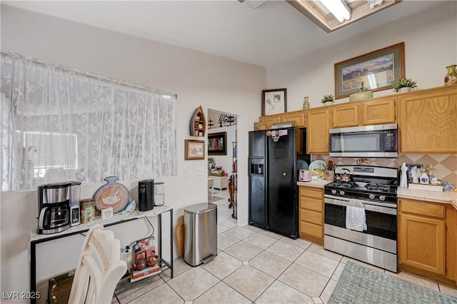 6009 Flowering Plum Ave, Las Vegas, NV 89142 - kitchen featuring stainless steel appliances, tasteful backsplash, and light tile patterned floors