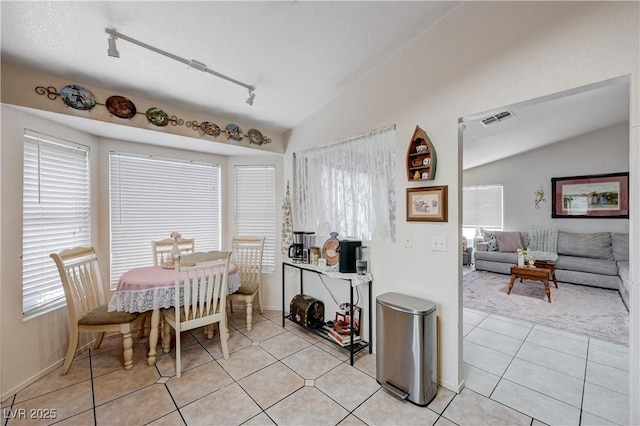 6009 Flowering Plum Ave, Las Vegas, NV 89142 - dining space with lofted ceiling, plenty of natural light, light tile patterned floors, and rail lighting