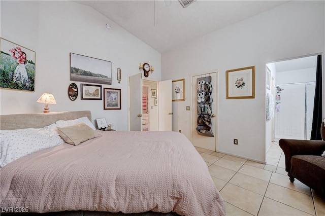 6009 Flowering Plum Ave, Las Vegas, NV 89142 - bedroom featuring light tile patterned flooring, high vaulted ceiling, a walk in closet, and ensuite bath