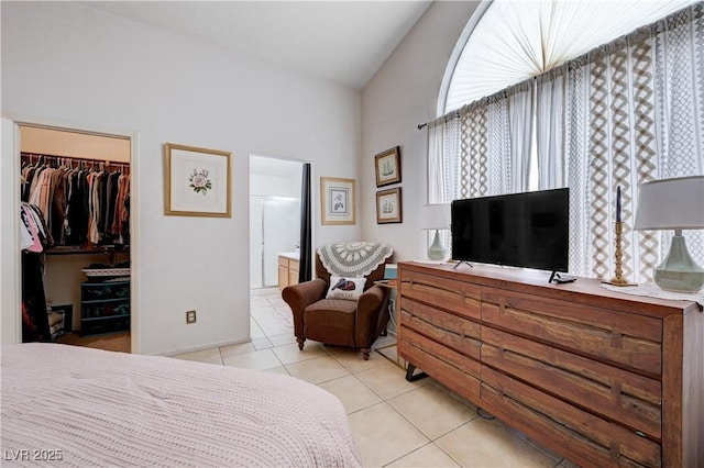 6009 Flowering Plum Ave, Las Vegas, NV 89142 - bedroom featuring a spacious closet, light tile patterned floors, a closet, and lofted ceiling