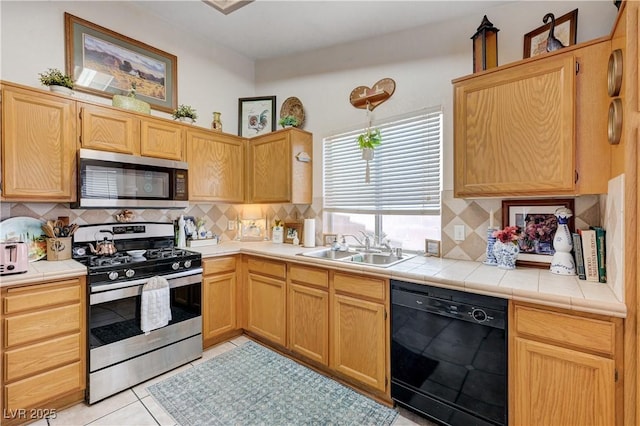 6009 Flowering Plum Ave, Las Vegas, NV 89142 - kitchen featuring appliances with stainless steel finishes, decorative backsplash, light tile patterned floors, and tile counters