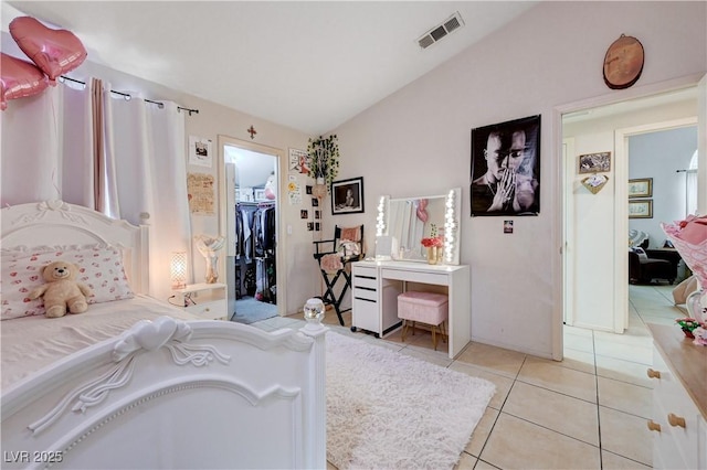 6009 Flowering Plum Ave, Las Vegas, NV 89142 - tiled bedroom featuring vaulted ceiling, a walk in closet, and a closet