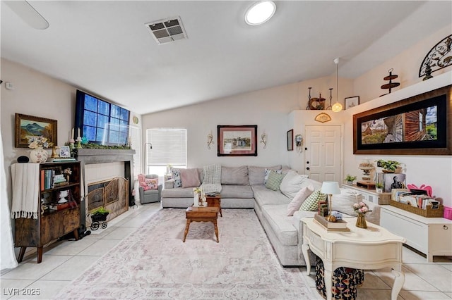 6009 Flowering Plum Ave, Las Vegas, NV 89142 - living area with light tile patterned floors, a fireplace, and vaulted ceiling