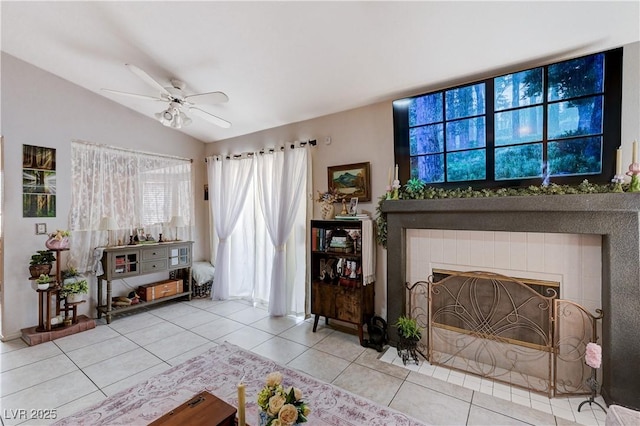 6009 Flowering Plum Ave, Las Vegas, NV 89142 - living room featuring tile patterned floors, a ceiling fan, lofted ceiling, and a tiled fireplace