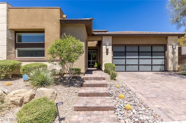 975 Amara Way, Henderson, NV 89052 - view of front of property featuring stucco siding, decorative driveway, and a garage