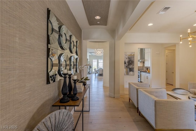 975 Amara Way, Henderson, NV 89052 - hall with a chandelier, light wood-style floors, an accent wall, and recessed lighting