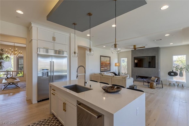 975 Amara Way, Henderson, NV 89052 - kitchen with stainless steel appliances, light wood-style floors, recessed lighting, white cabinetry, and decorative light fixtures