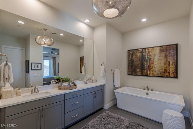 975 Amara Way, Henderson, NV 89052 - full bathroom featuring double vanity, a freestanding bath, tile patterned flooring, recessed lighting, and ceiling fan