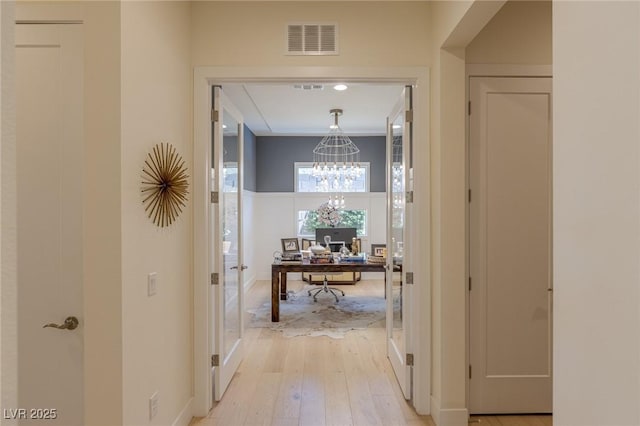 975 Amara Way, Henderson, NV 89052 - hallway with a desk, light wood-style flooring, and a chandelier