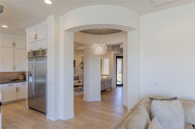 975 Amara Way, Henderson, NV 89052 - kitchen with built in fridge, light wood-type flooring, arched walkways, white cabinetry, and recessed lighting