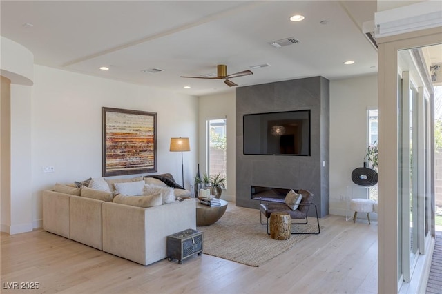 975 Amara Way, Henderson, NV 89052 - living area featuring light wood finished floors, a fireplace, a ceiling fan, and recessed lighting