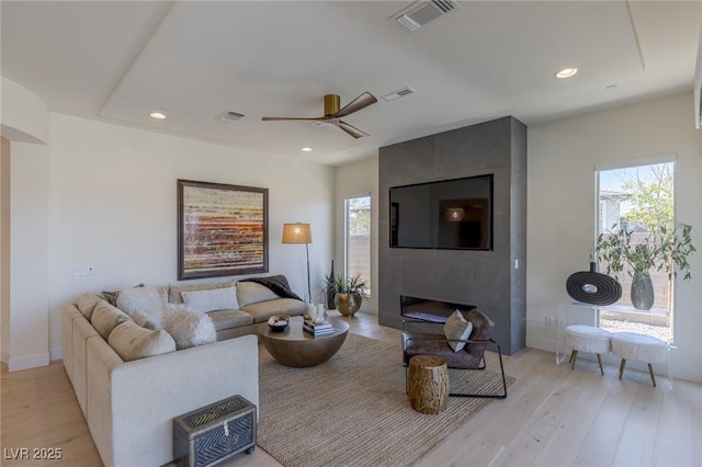 975 Amara Way, Henderson, NV 89052 - living area with light wood-style floors, ceiling fan, recessed lighting, and a large fireplace