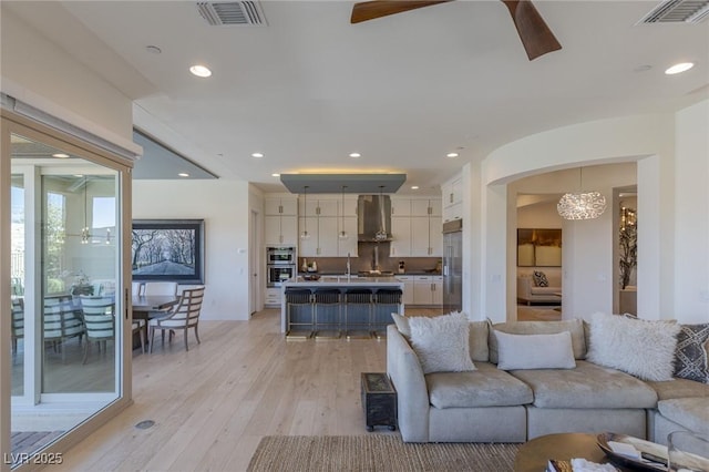 975 Amara Way, Henderson, NV 89052 - living room with ceiling fan, a chandelier, light wood-style flooring, and recessed lighting