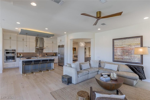 975 Amara Way, Henderson, NV 89052 - living area with a ceiling fan, light wood-type flooring, arched walkways, and recessed lighting