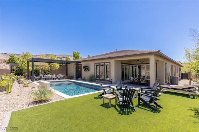 975 Amara Way, Henderson, NV 89052 - rear view of house with a patio area, stucco siding, outdoor lounge area, and a ceiling fan