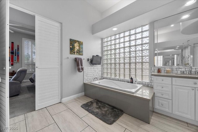 108 Valiente St, Las Vegas, NV 89144 - full bathroom with a bath, connected bathroom, vanity, wood finished floors, and a ceiling fan