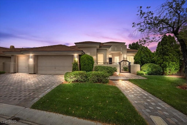108 Valiente St, Las Vegas, NV 89144 - view of front of home featuring stucco siding, an attached garage, a yard, decorative driveway, and a gate