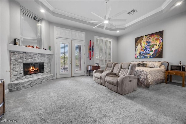 108 Valiente St, Las Vegas, NV 89144 - carpeted living room with crown molding, a ceiling fan, a raised ceiling, a glass covered fireplace, and recessed lighting