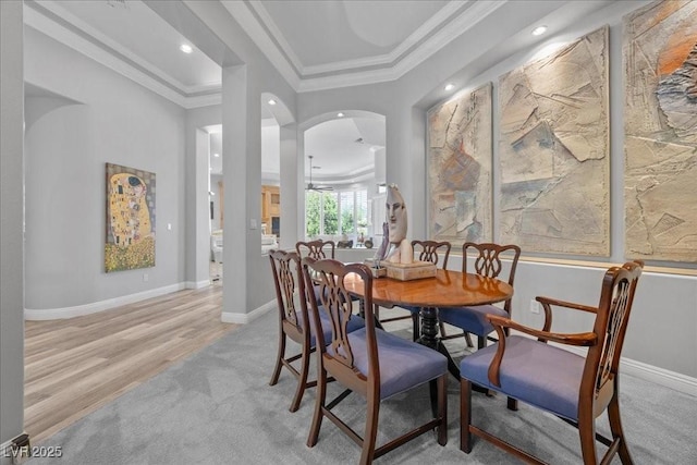 108 Valiente St, Las Vegas, NV 89144 - dining space with light colored carpet, arched walkways, crown molding, recessed lighting, and light wood-style flooring